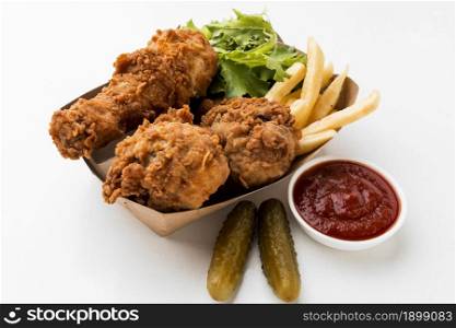 high angle fried chicken drumsticks with ketchup fries. Resolution and high quality beautiful photo. high angle fried chicken drumsticks with ketchup fries. High quality beautiful photo concept