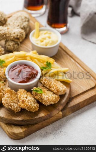 high angle fried chicken legs nuggets with fizzy drinks french fries