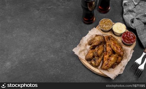 high angle fried chicken wings with variety sauces fizzy drinks. High resolution photo. high angle fried chicken wings with variety sauces fizzy drinks. High quality photo