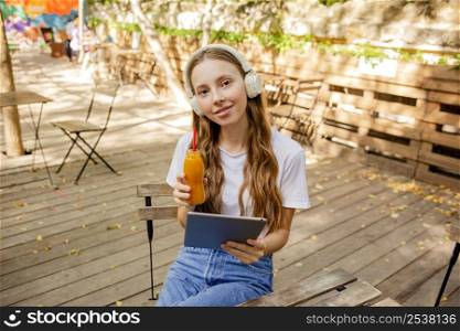 high angle girl with book fresh juice bottle