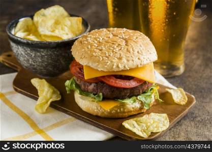 high angle glasses beer with cheeseburger potato chips
