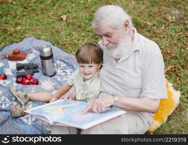 high angle grandpa reading grandson