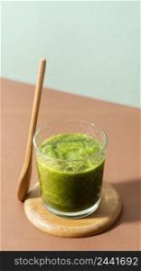 high angle green smoothie wooden spoon