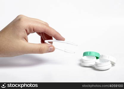 high angle hand holding tweezers contact lenses