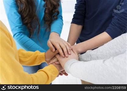 high angle kids forming hands stack