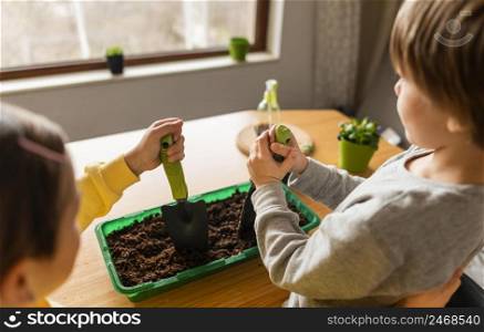 high angle kids watering crops home