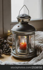 high angle lamp with candle pine cones blanket