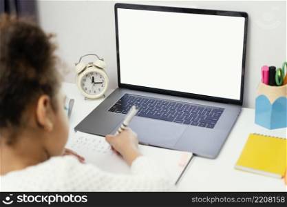 high angle little girl home during online school with laptop