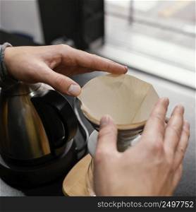 high angle male barista preparing coffee filter