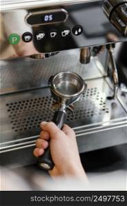 high angle male barista using coffee machine