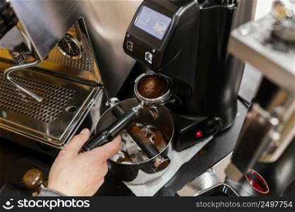high angle male barista using professional coffee machine