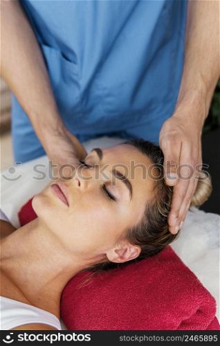 high angle male osteopathic therapist checking female patient s neck spine
