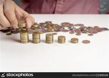 high angle man arranging stack coins