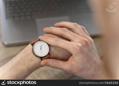 high angle man looking his watch. High resolution photo. high angle man looking his watch. High quality photo