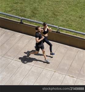 high angle man woman jogging together outdoors