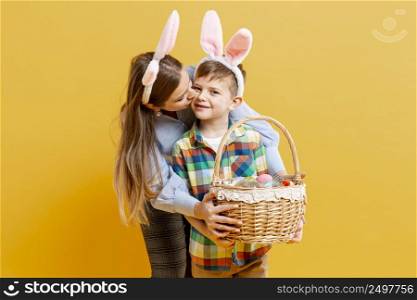 high angle mother son with basket painted eggs