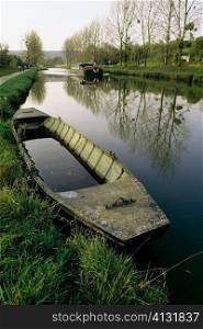 High angle of an old boat with a barge moving upstream, Burgundy Canal, France