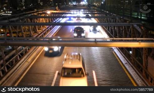 High angle of heavy traffic on Brooklyn Bridge at night. Also available as a time lapse.