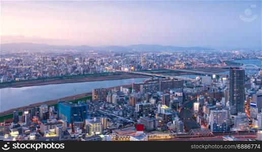 High angle panoramic view of Osaka city with Yodo river at sunset time. Japan