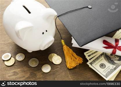 high angle piggy bank with academic cap coins