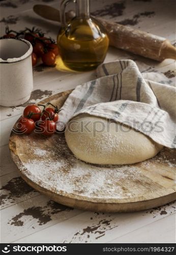 high angle pizza dough covered with cloth tomatoes. High resolution photo. high angle pizza dough covered with cloth tomatoes. High quality photo