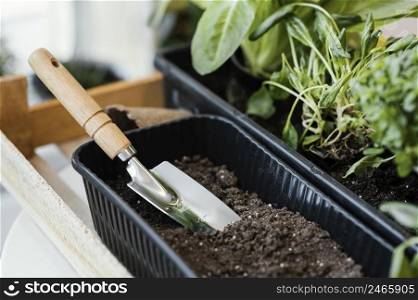 high angle plant pot with soil trowel