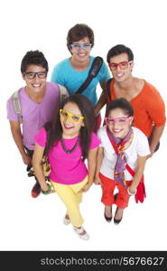 High angle portrait of university friends wearing colorful glasses on white background