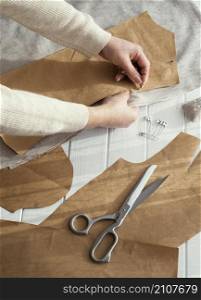 high angle seamstress with fabrics scissors