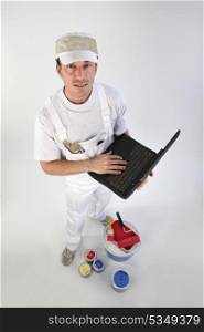 High-angle shot of a painter using his laptop