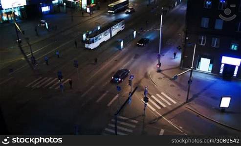 High angle shot of evening traffic in Tallin, Estonia. Crossroad with zebra and public transport stops