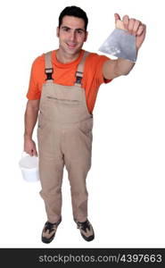 high angle shot of man with plaster knife