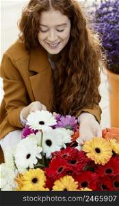 high angle smiley woman outdoors spring with bouquet flowers