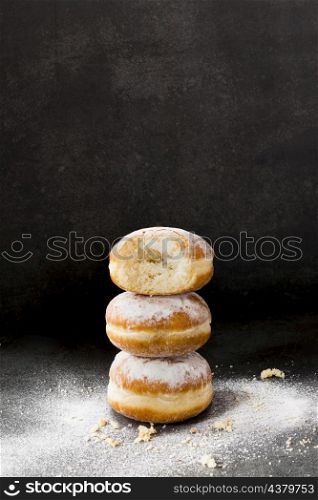 high angle stacked donuts with powdered sugar