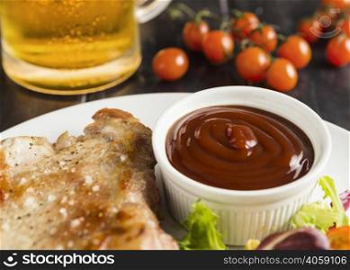 high angle steak plate with ketchup beer