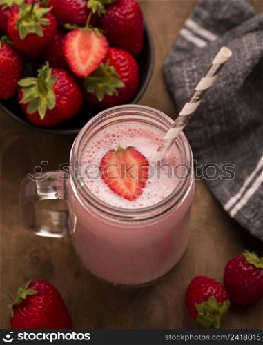 high angle strawberry milkshake with straw
