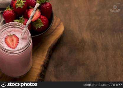 high angle strawberry milkshake with straw copy space