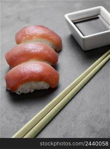 high angle sushi with sticks sauce