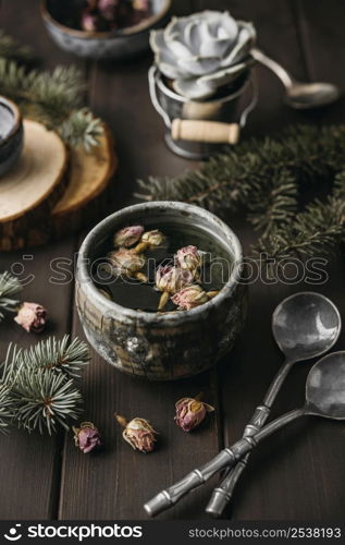 high angle tea with dried flowers rustic mug with teaspoons