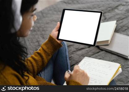 high angle teenage girl using tablet online school