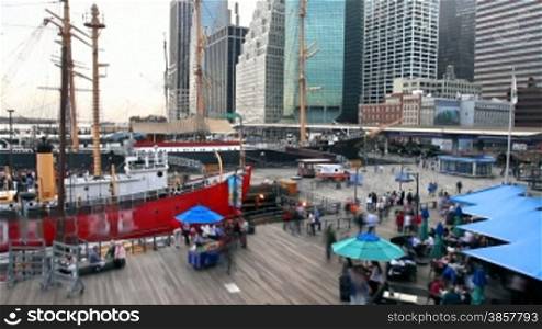 High angle time lapse of the crowds eating and passing through South Street Seaport in New York City.