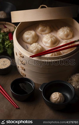 high angle traditional asian dumplings with chopsticks