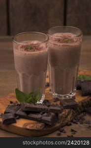 high angle two milkshake glasses with chocolate mint