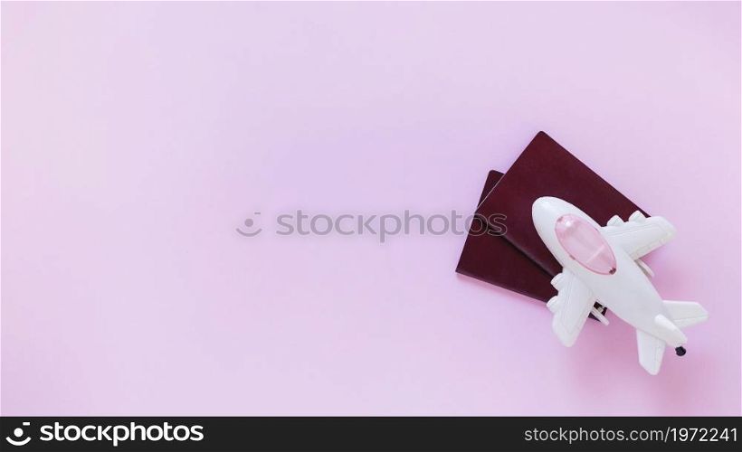 high angle view airplane passport pink surface. High resolution photo. high angle view airplane passport pink surface. High quality photo