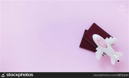high angle view airplane passport pink surface. High resolution photo. high angle view airplane passport pink surface. High quality photo