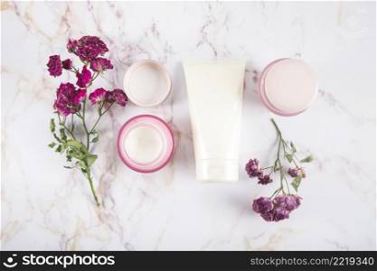 high angle view beauty creams flowers marble