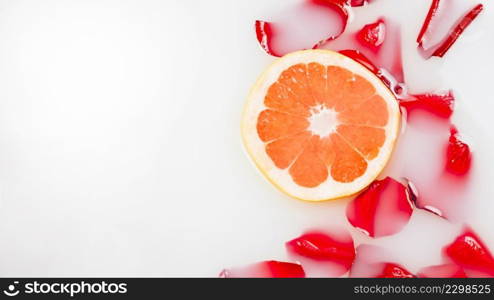 high angle view flower petals slice grapefruit floating milk