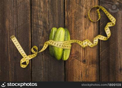 high angle view fresh cucumbers measuring tape wooden background. Resolution and high quality beautiful photo. high angle view fresh cucumbers measuring tape wooden background. High quality beautiful photo concept