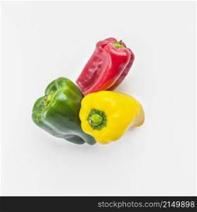 high angle view green yellow red bell peppers white background