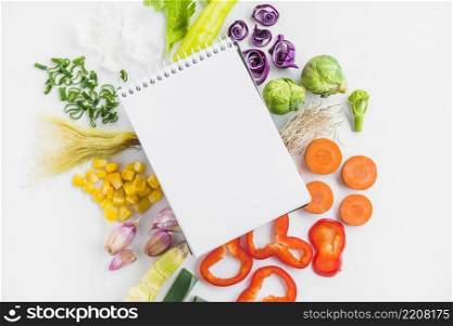 high angle view healthy raw vegetables spiral notepad