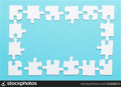 high angle view jigsaw puzzle frame blue backdrop